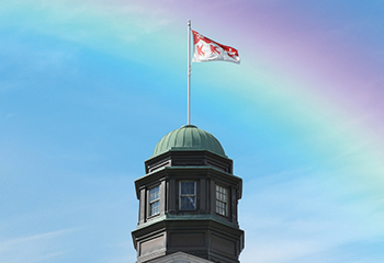 Photo of a rainbow over the McGill Arts building cupola