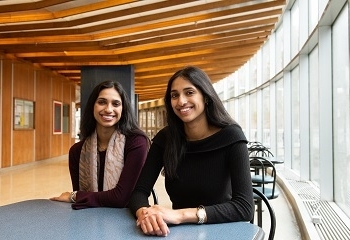 Two sisters sitting at a table