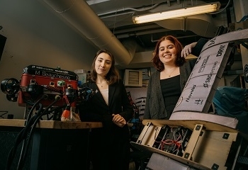 Two women standing next to a machine