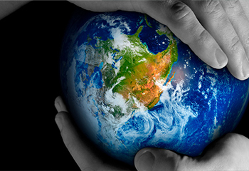 Photo of hands holding a globe